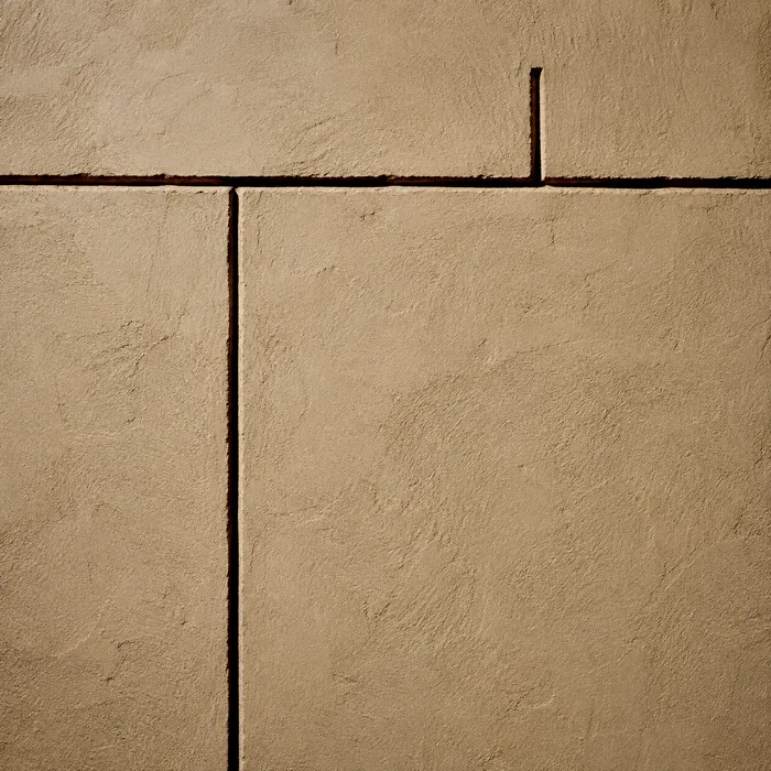A horizontal groove incised into plaster, with one long vertical groove descending from it and one short vertical groove rising beside it